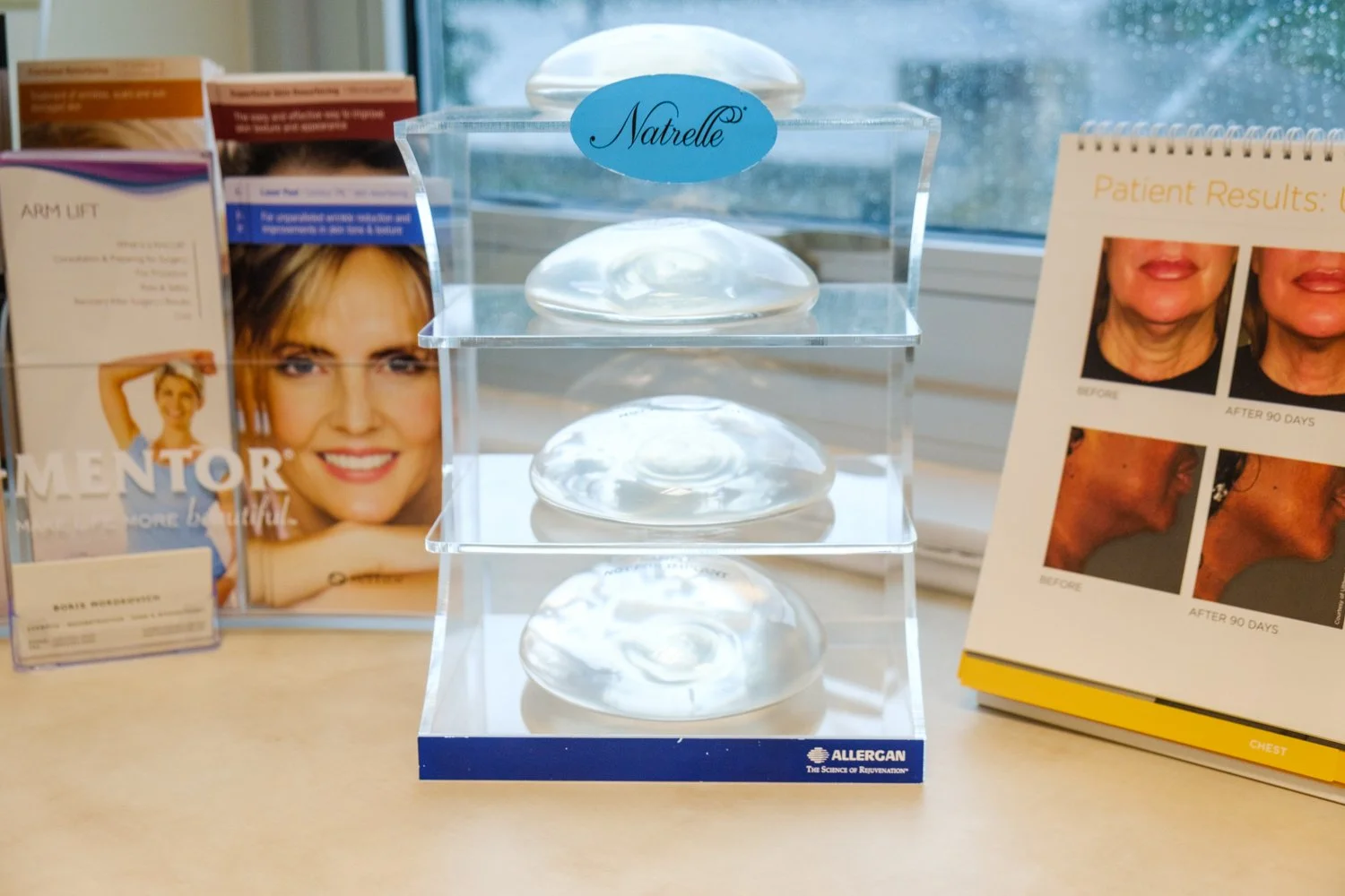 Natrelle breast implant display with sample sizes on desk at Cross Hudson Plastic Surgery consultation room
